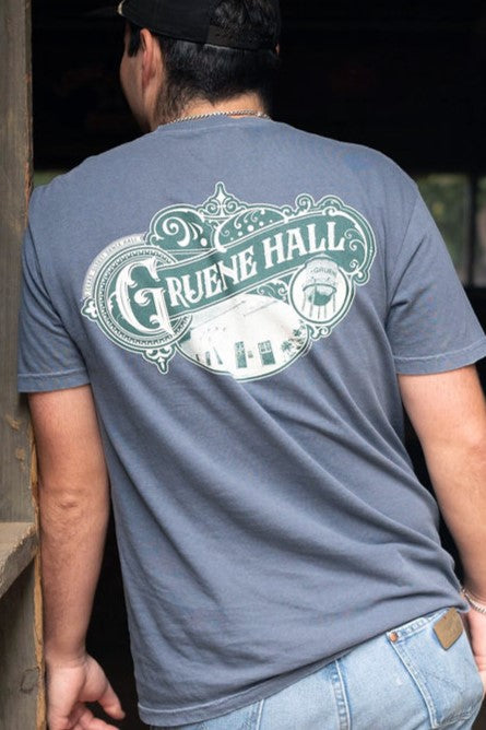 Person wearing a gray t-shirt with 'Gruene Hall' design on the back.